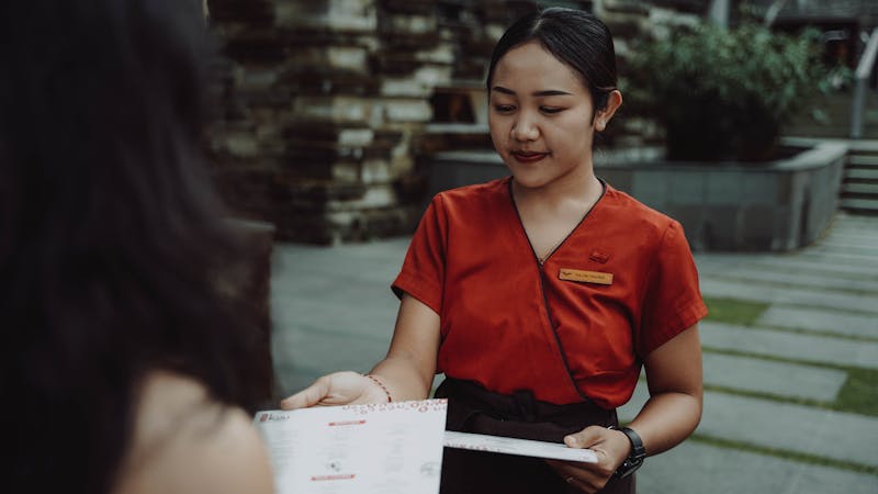 Chef demonstrating traditional pizza dough tossing